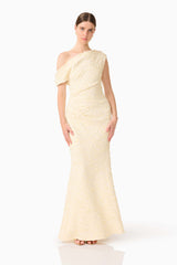 Brunette model wearing the CURAAE Faye One Shoulder Maxi Dress in Cream posed shot 