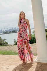 Brunette model wearing the Solene Halter Gown in Pink Floral campaign shot