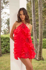 Brunette model wearing the Yvette Halter Mini Dress in Vermilion Red ghost shot 