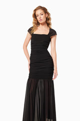 Blonde model wearing the Capra Maxi Dress In Black close up shot