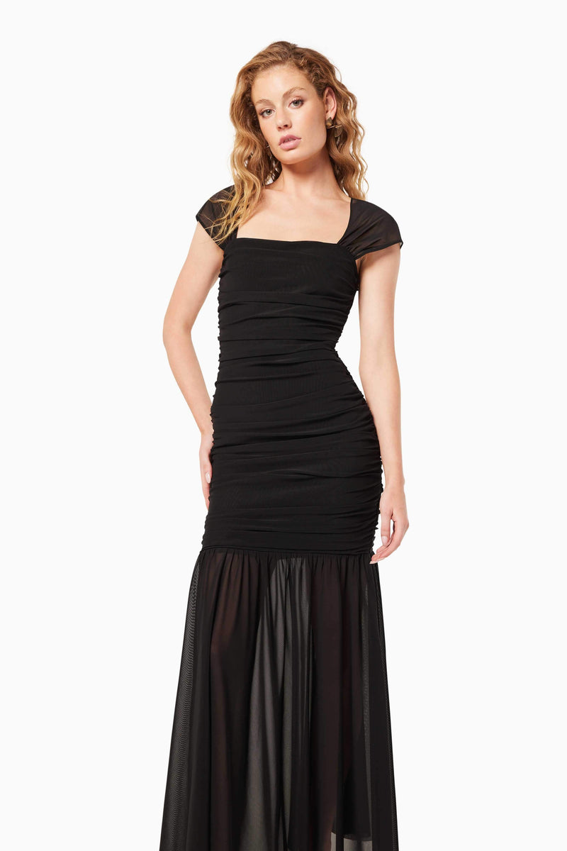 Blonde model wearing the Capra Maxi Dress In Black close up shot