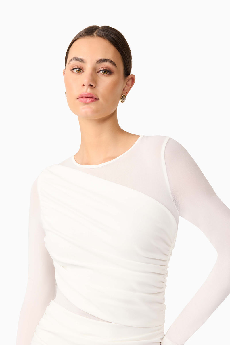 Brunette model wearing Darya Long Sleeve Mini Dress in White detail shot
