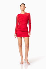Brunette model wearing Darya Long Sleeve Mini Dress in Red posed shot