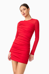 Brunette model wearing Darya Long Sleeve Mini Dress in Red close up shot