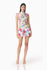 Brunette Model Wearing Rosette Sleeveless Mini Dress in Multi Floral Posed  Long Shot