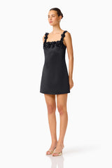 Brunette Model wearing Lucetta Shift Mini Dress in Black side shot