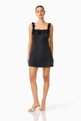 Brunette Model wearing Lucetta Shift Mini Dress in Black posed turned foot shot