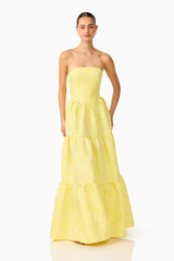 Brunette Model wearing the Luella Strapless Gown in Yellow posed one hand on hip shot