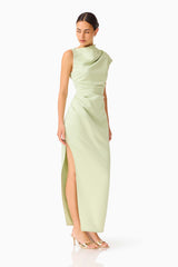 Brunette model wearing the Coralie Maxi Gown in Sage Green posed looking away shot