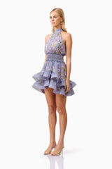Blonde model wearing Milena Halter Mini Dress in Purple Floral side shot
