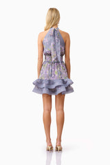 Blonde model wearing Milena Halter Mini Dress in Purple Floral back shot