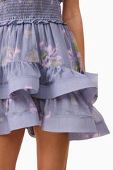 Blonde model wearing Milena Halter Mini Dress in Purple Floral back shot