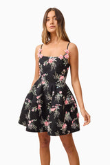 Brunette model wearing Gaia Floral Mini Dress in Black close up shot