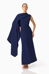 Leonara Asymmetric Cape Maxi Dress in Deep Navy with high neckline posed hands on hip shot