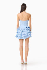 Brunette model wearing the Liora Strapless Tiered Mini Dress in Sky Blue back shot