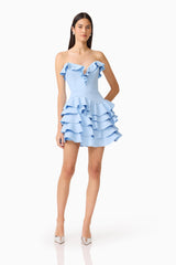 Brunette model wearing the Liora Strapless Tiered Mini Dress in Sky Blue posed hand on hip shot