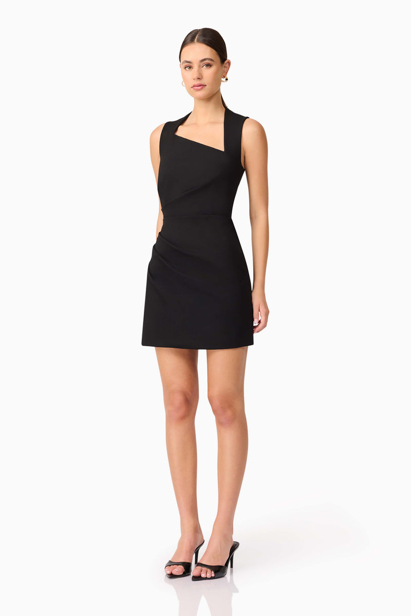 Brunette model wearing Alina Asymmetrical Mini Dress in Black side shot