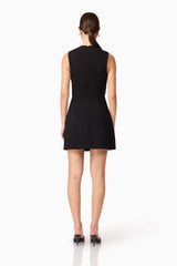 Brunette model wearing Alina Asymmetrical Mini Dress in Black back shot