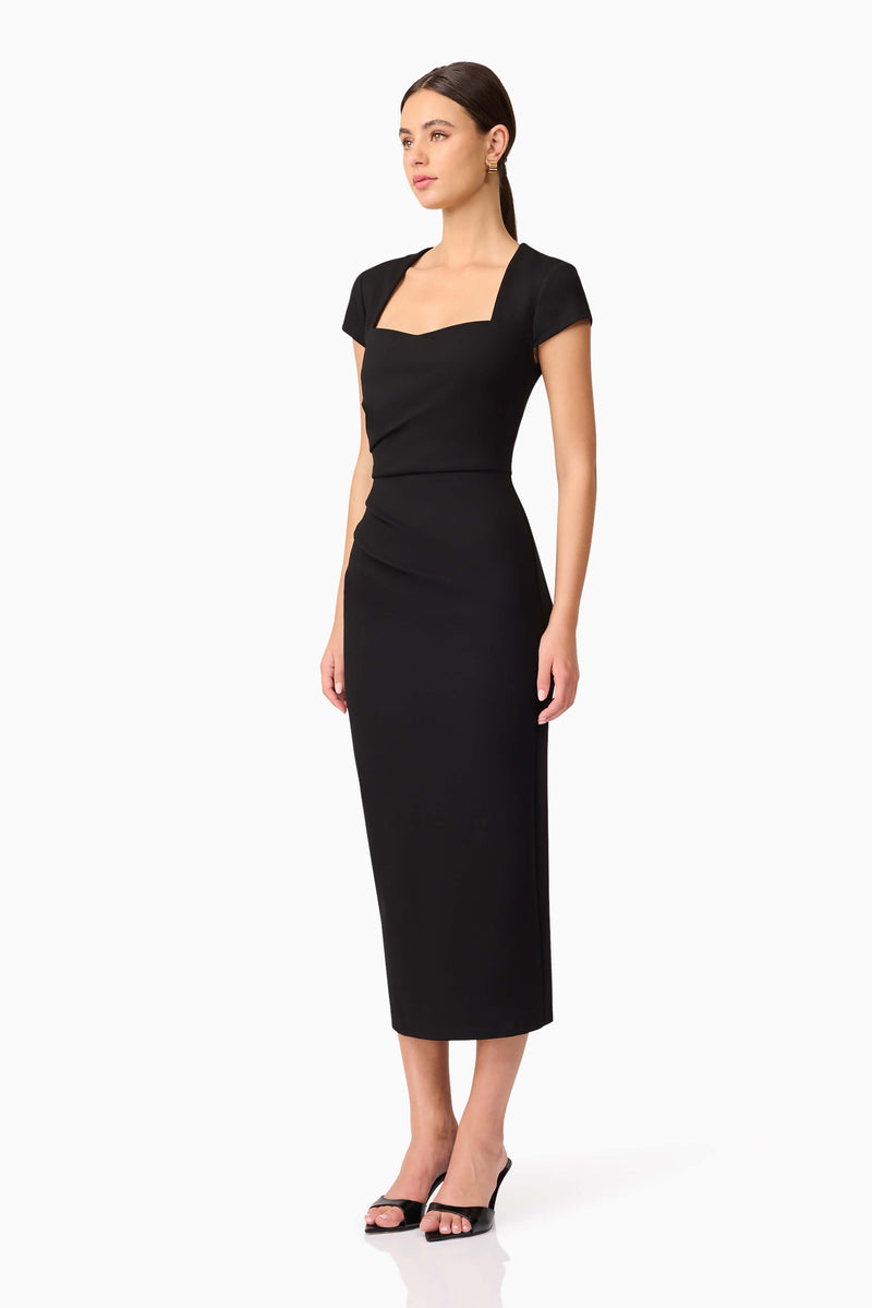Brunette model wearing the Alina Fitted Midi Dress in Black side shot