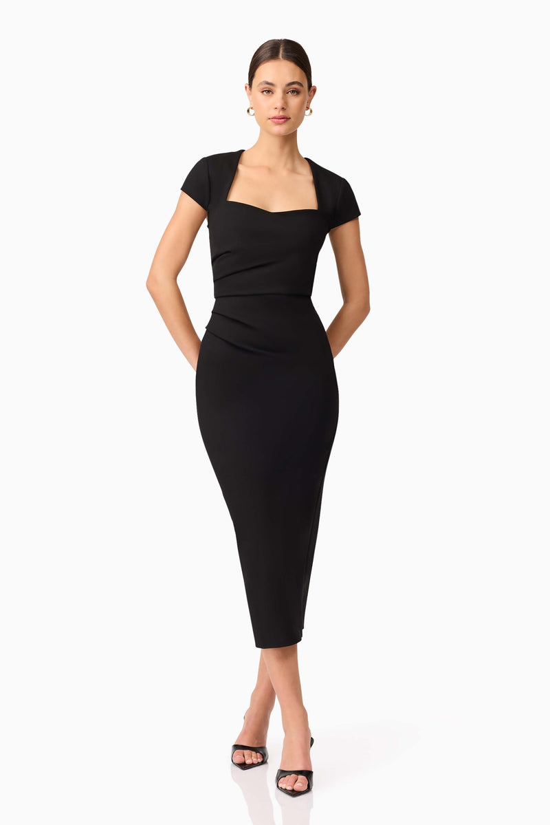 Brunette model wearing the Alina Fitted Midi Dress in Black posed hand nehind hips shot