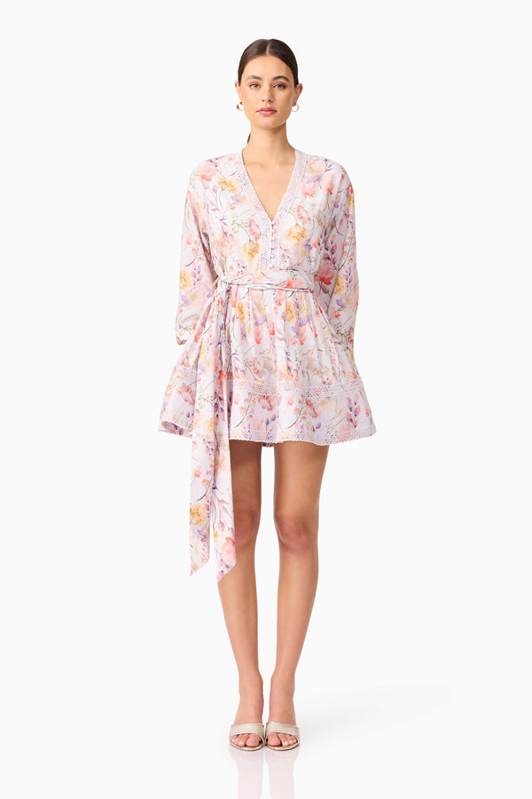 Brunette model wearing Ines Long Sleeve Mini Dress in Purple Floral font shot