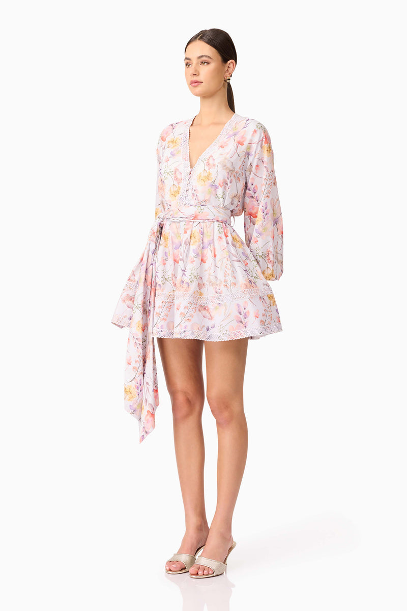 Brunette model wearing Ines Long Sleeve Mini Dress in Purple Floral side shot