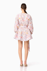 Brunette model wearing Ines Long Sleeve Mini Dress in Purple Floral back shot