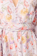 Brunette model wearing Ines Long Sleeve Mini Dress in Purple Floral detail shot