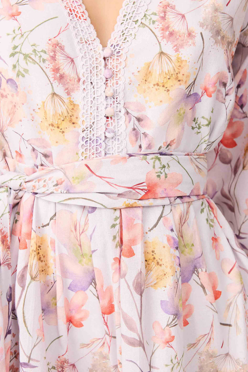 Brunette model wearing Ines Long Sleeve Mini Dress in Purple Floral detail shot