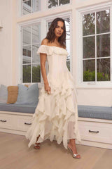 Brunette model wearing the Yvette Off Shoulder Gown in White campaign shot 
