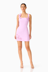 Brunette model wearing the Trompe 3D Mini Dress in Purple posed shot 