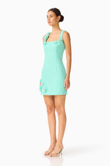 Brunette model wearing the Trompe 3D Mini Dress in Mint Green side shot 