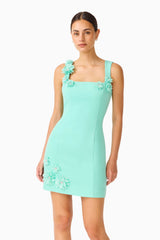 Brunette model wearing the Trompe 3D Mini Dress in Mint Green close up shot 