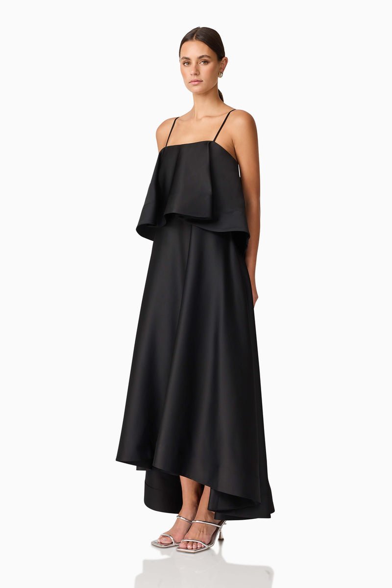 Brunette model wearing Reyna Tiered Maxi Dress in Black side shot
