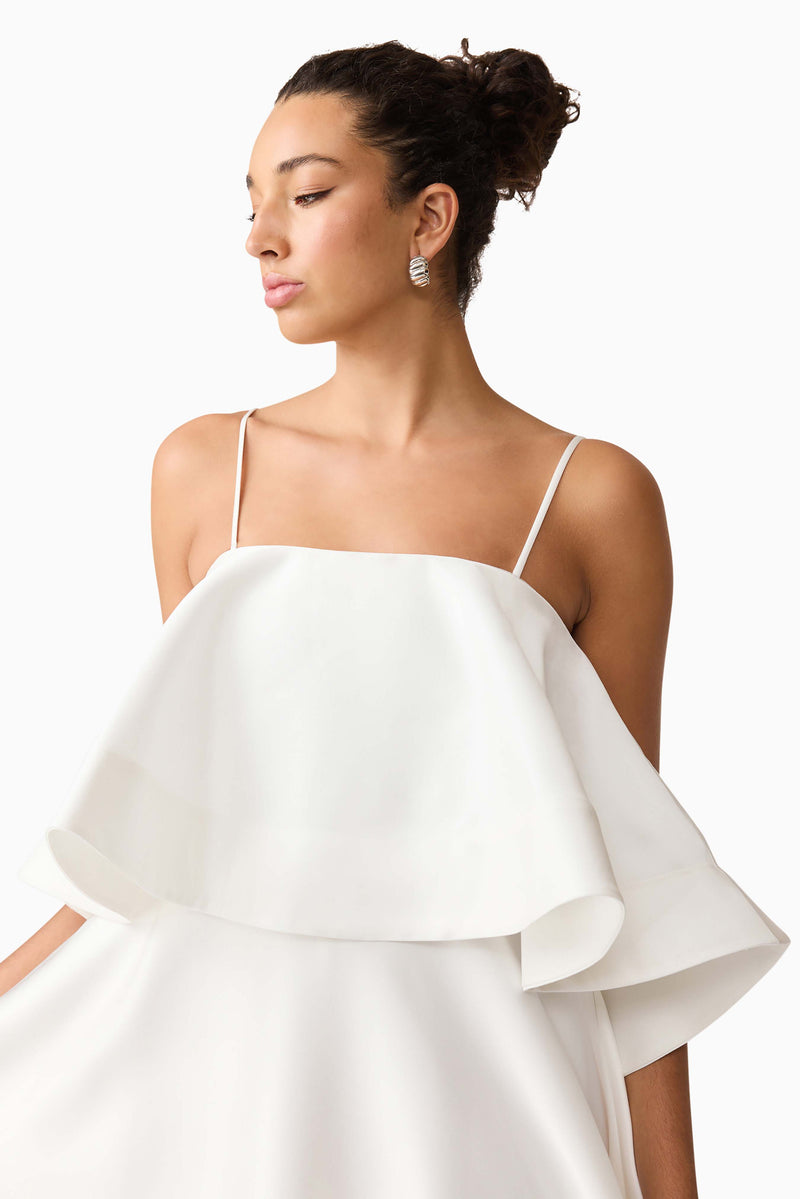 Brunette model wearing Reyna Tiered Maxi Dress in White close up looking away shot