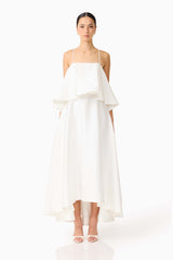 Brunette model wearing Reyna Tiered Maxi Dress in White front shot