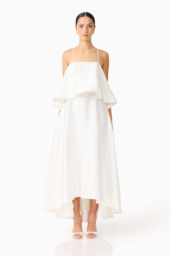 Brunette model wearing Reyna Tiered Maxi Dress in White front shot