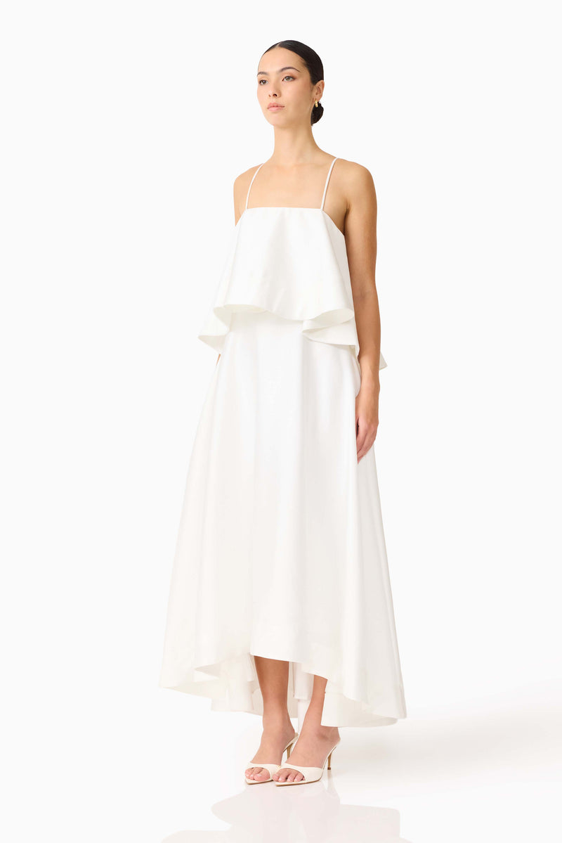 Brunette model wearing Reyna Tiered Maxi Dress in White side shot