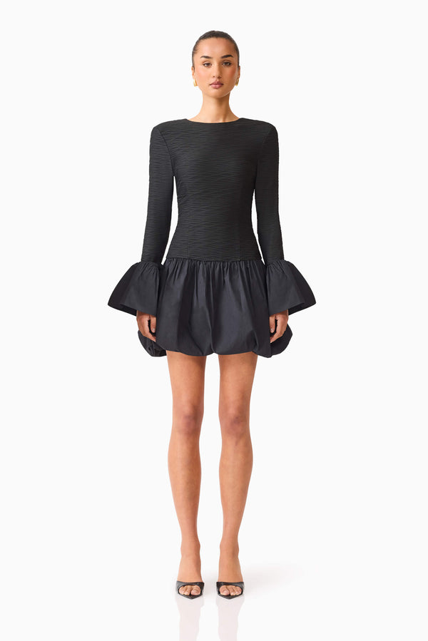 Brunette model wearing the Theodora Long Sleeve Mini Dress in Black front shot