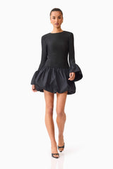 Brunette model wearing the Theodora Long Sleeve Mini Dress in Black posed shot