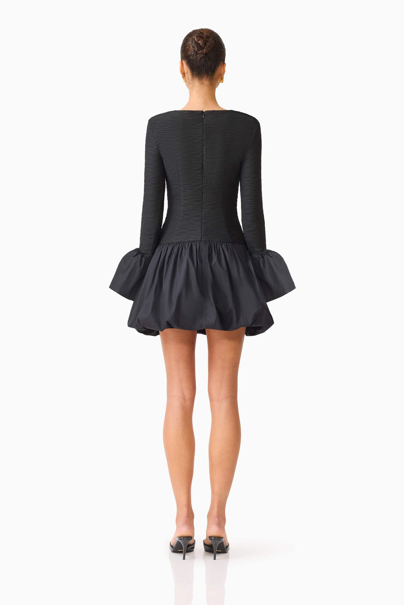 Brunette model wearing the Theodora Long Sleeve Mini Dress in Black back shot
