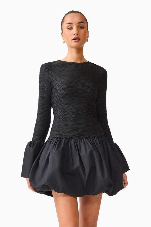 Brunette model wearing the Theodora Long Sleeve Mini Dress in Black close up shot
