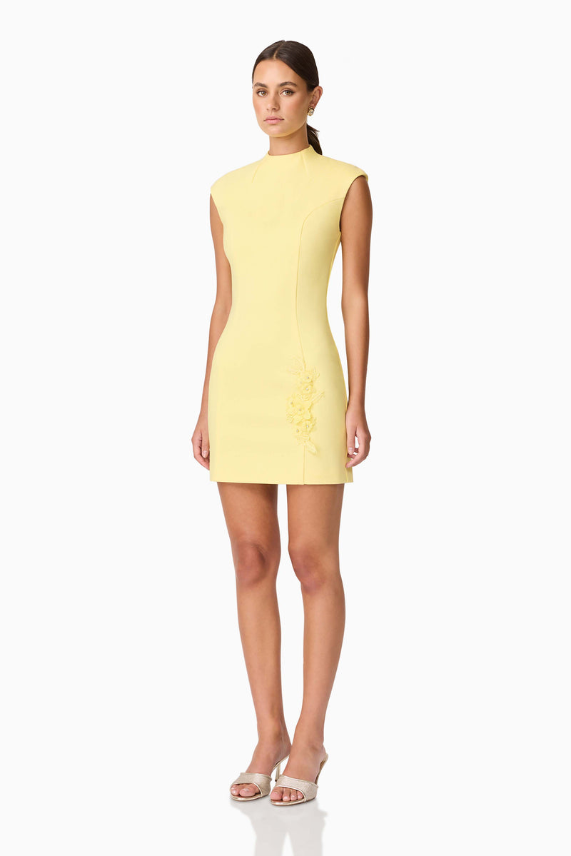 Brunette model wearing Evee High Neck Mini Dress in Yellow side shot