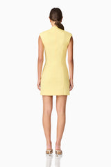 Brunette model wearing Evee High Neck Mini Dress in Yellow back shot