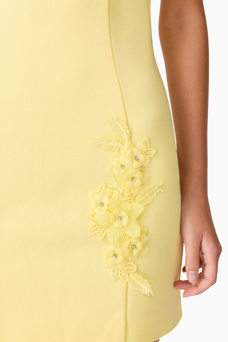 Brunette model wearing Evee High Neck Mini Dress in Yellow detail shot
