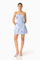 Aurae Embellished Mini Dress in Sky Blue with a square neckline & tulip skirt posed hands behind hips shot