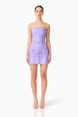 Brunette model wearing the Alya Strapless Mini Dress in Purple front shot 