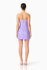 Brunette model wearing the Alya Strapless Mini Dress in Purple back shot 