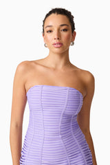 Brunette model wearing the Alya Strapless Midi Dress in purple close up shot