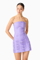Brunette model wearing the Alya Strapless Mini Dress in Purple close up looking down shot 